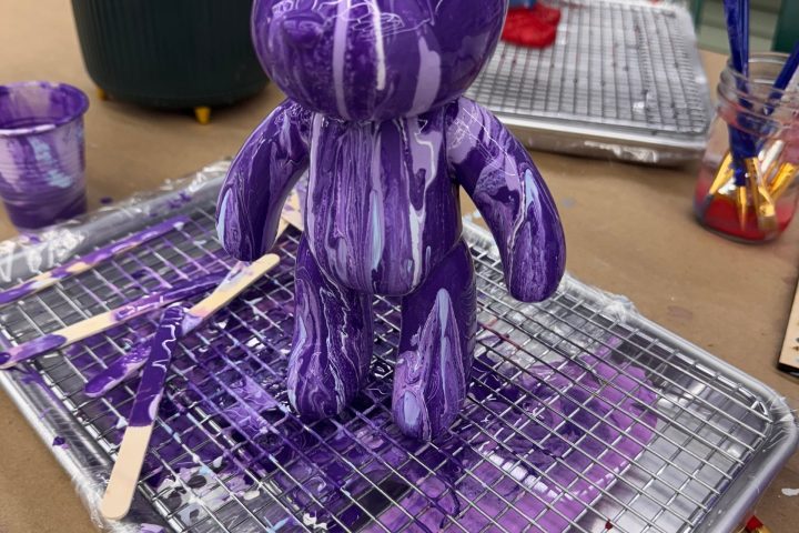 a basket filled with purple flowers on a table