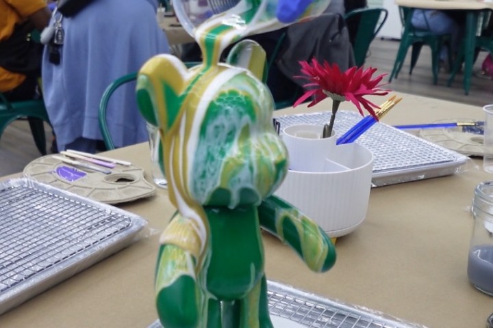 a group of people sitting at a desk with a laptop on a table